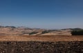 Alta Irpienia, windy hills in full sun. Summer, wheat fields, asphalt ribbon curving towards the sky. Italy, Campania Royalty Free Stock Photo