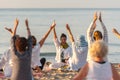 Yoga instructor leading a group session at sunset on the beach in Altafulla, Tarragona, Spain