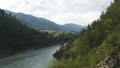 Altai landscape. River, mountains, forest. Summer trip to Siberia