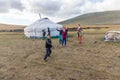 Altai, Mongolia - June 14, 2017: Children play outside. Throwing ground at passing cars