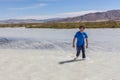 Altai, Mongolia - June 14, 2017: Man crosses a white mountain river on foot. Altai, Mongolia