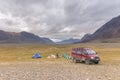 Altai, Mongolia - June 14, 2017: Tourists camping in Mongolian hills. Three tents under the open cloudy sky