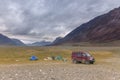 Altai, Mongolia - June 14, 2017: Tourists camping in Mongolian hills. Tents under the open cloudy sky