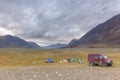 Altai, Mongolia. Tourists camping in Mongolian hills. Three tents under the open cloudy sky