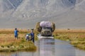 Altai, Mongolia - June 14, 2017: Truck on a road covered with water after a flood. Altai, Mongolia