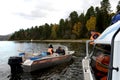 A transport police officer talks to a boatmaster on Lake Teletskoye. Altai Republic Royalty Free Stock Photo