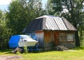 Nice wooden house with small boat. House in the countryside, Teletskoye lake, Altai mountains Royalty Free Stock Photo