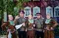 Altai, Russia-July 24, 2018.two Cossacks in military uniform sing a song with their wives