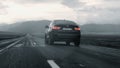 ALTAI, RUSSIA - 29 JUNE 2021: Black BMW X4 drives down the highway with mountain scenery. BACK View Royalty Free Stock Photo