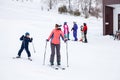 A mother and her son skiers slides down the mountain over white snow in a sports tourist base Turquoise Katun. Seasonal sports