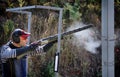 Shooter from a gun practicing shooting on plates in nature Royalty Free Stock Photo