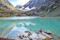 Republic of Altai, Ust-Koksinsky district, Russia. Young woman meditates on a stone on the lake Kuiguk Kuyguk