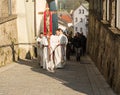 Altar boys walk at the head of the Palm Sunday