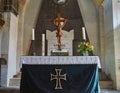 Altar of the church of the manor with a crucifix and white candles