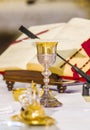 Altar with missal and host which becomes the body of Christ and chalice to receive the wine, the blood of Christ Royalty Free Stock Photo