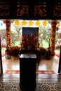 Altar with the image of Buddha at the entrance of the main hall of the Phap Bao Temple. Hoi An, Vietnam. Vertical view