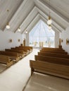 Altar and interior of the catalytic church with wooden benches and a large atrium window Royalty Free Stock Photo