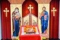 Altar in Orthodox church decorated for Christmas. A burning wax candles, cross and icons in monastery. Christian religion
