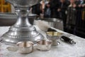 On the altar of the Orthodox Church there is a bowl with holy water with the inscription `Holy Spirit` and a sprinkler for sprinkl Royalty Free Stock Photo