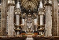 Altar with statues and a huge stained glass window in the Duomo. Italy, Milan Royalty Free Stock Photo