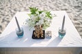 Altar with ganesha statue, flower and candle on the table for beach wedding