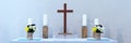 Altar with a wooden cross and four candles against a light background. Panorama Royalty Free Stock Photo