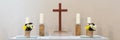 Altar with a wooden cross and four candles against a light background. Panorama Royalty Free Stock Photo