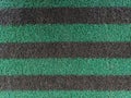 Alternating black-green stripe pattern on carpet for modern building decoration