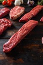 Alternative beef cut denver steak close up in front of other cuts in butchery on old wood table side view selective focus Royalty Free Stock Photo