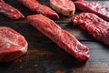 Alternative beef cut denver steak close up in front of other cuts in butchery on old wood table side view selective focus Royalty Free Stock Photo