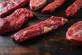 Alternative beef cut machete skirt steak close up in front of other cuts in butchery on old wood table side view selective focus Royalty Free Stock Photo
