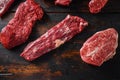 Alternative beef cut machete skirt steak near tri-tip and top blade oyster cuts close up in front of other cuts in butchery on old Royalty Free Stock Photo