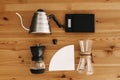 Alternative coffee brewing method, flat lay. Stylish accessories and items for alternative coffee on wooden table. Kettle, scales