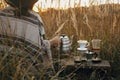 Alternative coffee brewing outdoors in travel. Hipster woman holding hot kettle and coffee cup, glass flask, geyser maker on