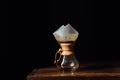 Alternative coffee in chemex with filter cone on wooden table