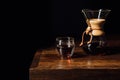 alternative coffee in chemex and glass mug on wooden table