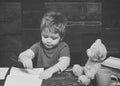 Alternative education. Small kid writing in textbook. Diligent boy learning letters. Early learning concept Royalty Free Stock Photo