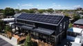 Alternative energy. Solar panels on the roof of a black industrial or RND building. autonomous power supply