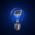 Alternative energy source. Light bulb with solar panel on background Royalty Free Stock Photo