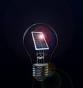 Alternative energy source. Light bulb with solar panel on background Royalty Free Stock Photo