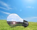Alternative energy source. Light bulb with solar panels Royalty Free Stock Photo