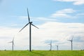 Alternative energy source. Wind turbines in field under sky Royalty Free Stock Photo