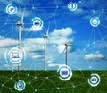 Alternative energy source. Wind turbines in field under sky and scheme Royalty Free Stock Photo