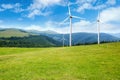 Alternative energy source. Wind turbines in mountains under sky Royalty Free Stock Photo