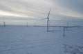 Alternative energy sources. Eco-friendly electricity. Snowy field and wind turbine sunrise in winter. Aerial view of Royalty Free Stock Photo
