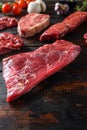 Alternative Flank bavette or flap steak beef t steak near tri-tip and top blade oyster cuts close up in front of other cuts in Royalty Free Stock Photo