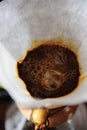 Alternative manual coffee brewing with paper filter. Blooming close up