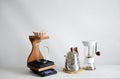 Alternative manual coffee brewing. Pink ceramic origami dripper. Wooden stand. Gringer, gooseneck kettle