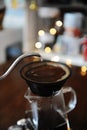 Alternative manual coffee brewing in porous ceramic paperless dripper filter. Gooseneck kettle. Blurry light background
