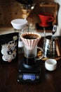 Alternative manual hand coffee brewing in pink ceramic origami dripper with paper filter. Grinder. Gooseneck kettle